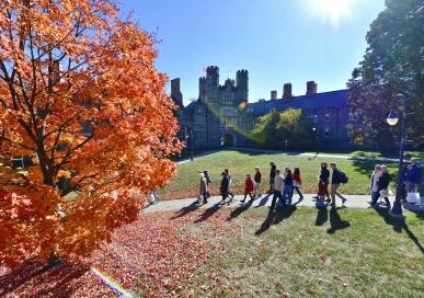 Students and families walking by Rockefeller Hall