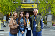 Family smiling at the camera in front of Pem Arch